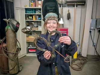 Student Showing off Welding Work