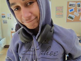Student Showing Off Photo Jewelry Project