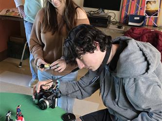 Student taking a photo with a digital camera.