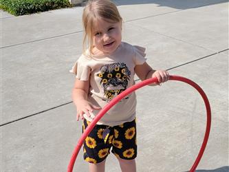 Student smiling with hula hoop